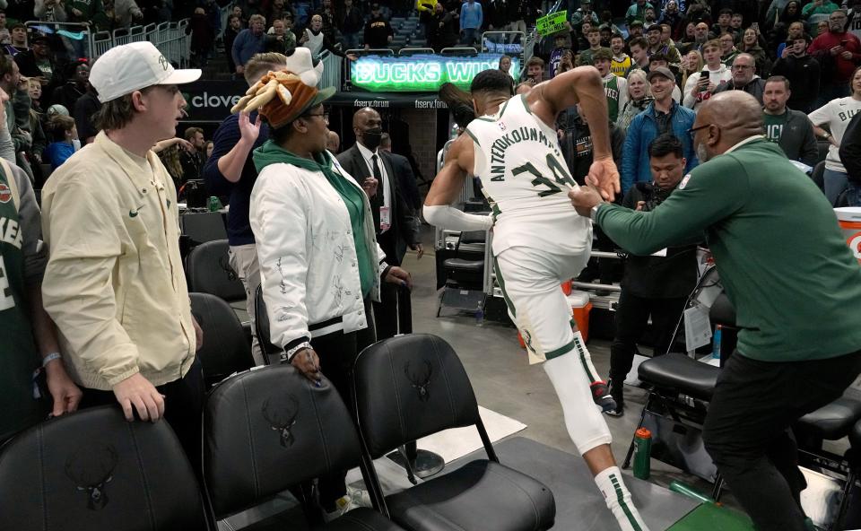 Milwaukee Bucks forward Giannis Antetokounmpo races down the tunnel toward the Indiana Pacers locker room in search of the game ball Wednesday night after breaking the Bucks' single-game scoring record with 64 points.