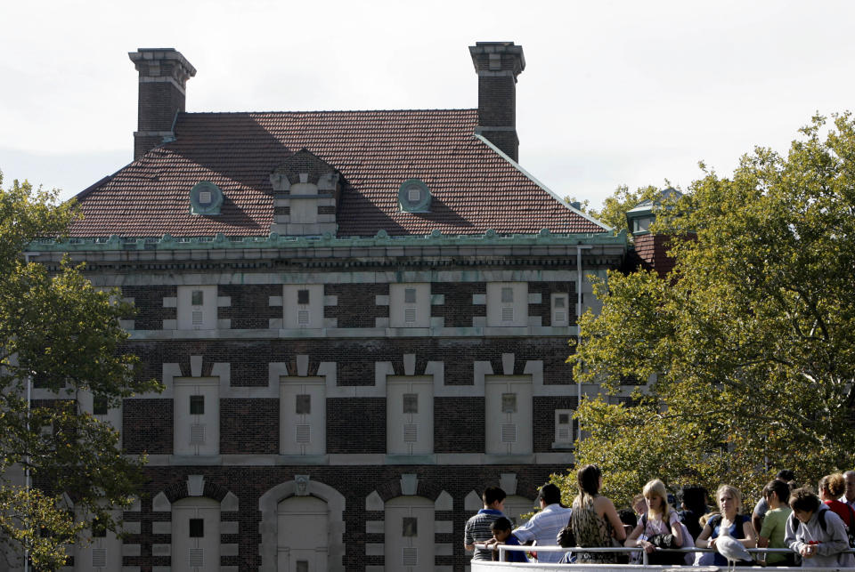 FILE - This Oct. 22, 2007, file photo shows the general hospital, behind some tourists on the south side of Ellis Island in the New York harbor. The National Trust for Historic Preservation announces its 2012 list of the 11 most endangered historic places. This year’s list includes historic U.S. Post Office buildings nationwide, the historic Atlanta district where Martin Luther King Jr. was born, the boyhood home of Malcolm X in Boston, the hospital complex at Ellis Island in New York Harbor, and the courthouses of Texas, among others. (AP Photo/Seth Wenig, File)