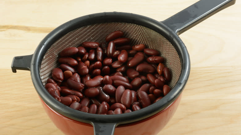 beans in strainer over bowl