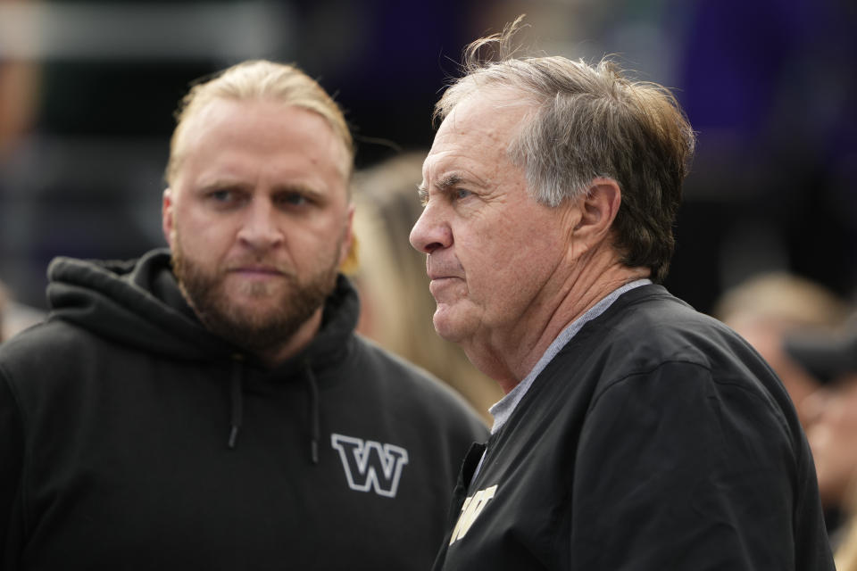 Former New England Patriots head coach Bill Belichick, right, stands with son and Washington defensive coordinator Steve Belichick, left, before an NCAA college football game against Michigan, Saturday, Oct. 5, 2024, in Seattle. (AP Photo/Lindsey Wasson)