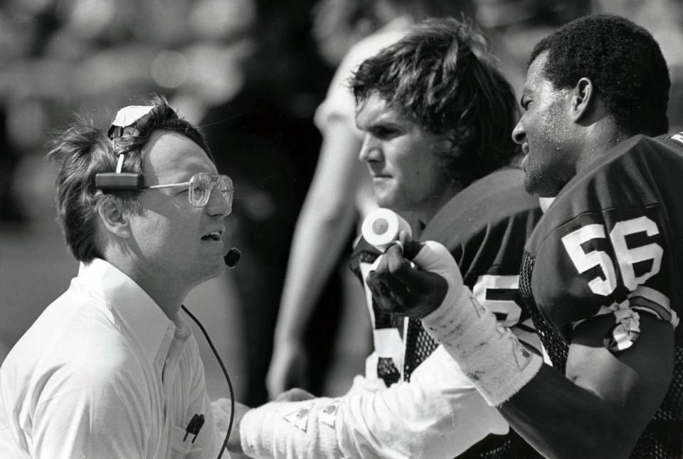 Browns head coach Marty Schottenheimer talks to linebackers Clay Matthews (57) and Chip Banks (56) during the 1985 AFC Divisional Playoff Game against the Miami Dolphins at the Orange Bowl, Jan 4, 1986. Miami defeated Cleveland 24-21. (USA TODAY Sports)