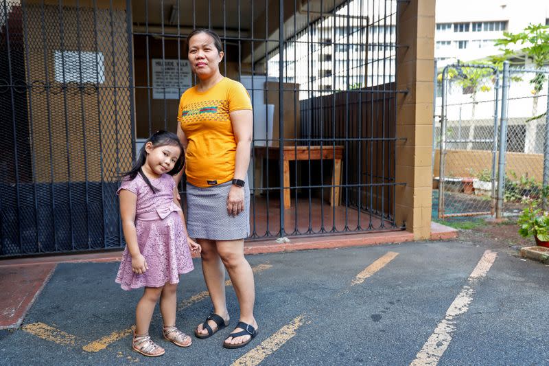 FILE PHOTO: Judith Ramirez poses with her daughter Mary Ashley outside their home in Honolulu