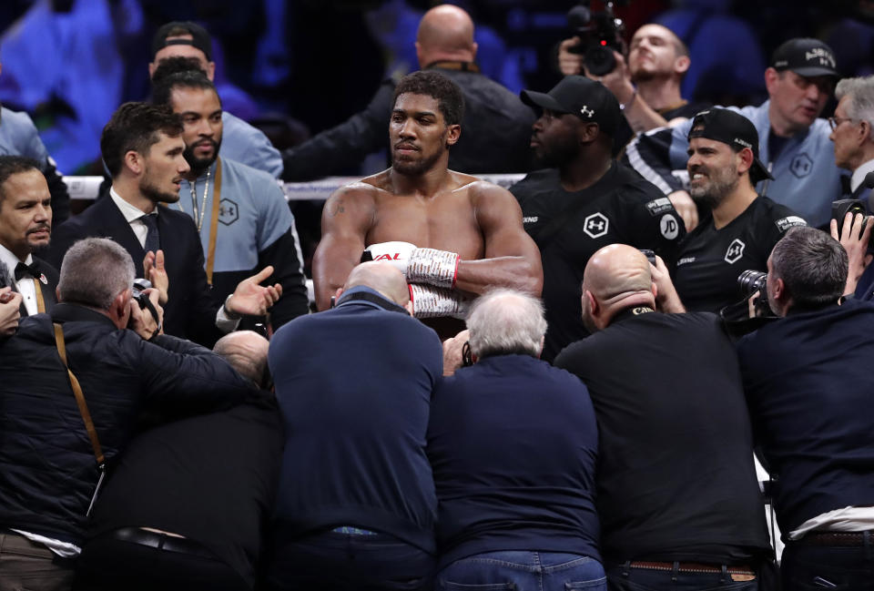 Britain's Anthony Joshua celebrates after beating Andy Ruiz Jr. to win their World Heavyweight Championship contest at the Diriyah Arena, Riyadh, Saudi Arabia early Sunday Dec. 8, 2019. (AP Photo/Hassan Ammar)