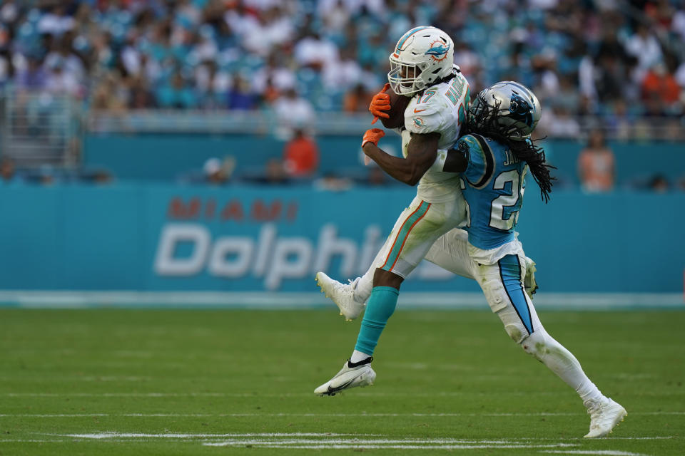 Miami Dolphins wide receiver Jaylen Waddle (17) is tackled by Carolina Panthers cornerback Donte Jackson (26) during the second half of an NFL football game, Sunday, Nov. 28, 2021, in Miami Gardens, Fla. (AP Photo/Lynne Sladky)