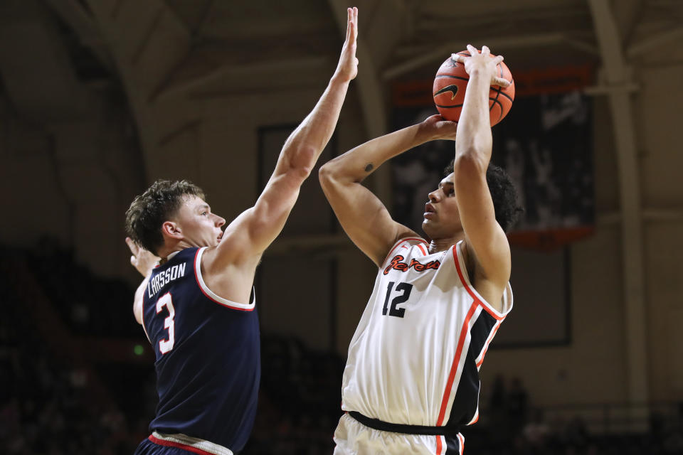 Oregon State forward Michael Rataj (12) shoots over Arizona guard Pelle Larsson (3) during the first half of an NCAA college basketball game Thursday, Jan. 25, 2024, in Corvallis, Ore. (AP Photo/Amanda Loman)