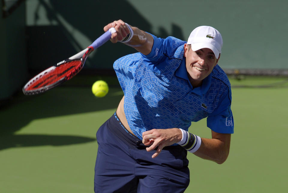 John Isner serves to Novak Djokovic, of Serbia, during their semifinal at the BNP Paribas Open tennis tournament, Saturday, March 15, 2014, in Indian Wells, Calif. Djokovic won 7-5, 6-7 (2), 6-1. (AP Photo/Mark J. Terrill)