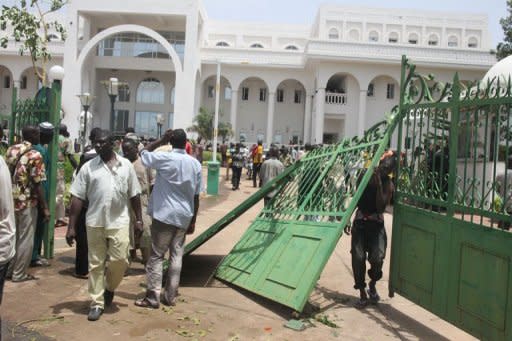 Some of thousands of Malians protest in Bamako against a transition deal given to coup leader Amadou Sanogo after breaking the gates of the presidential palace. Some protesters accused Sanogo of "treason" for accepting the arrangement