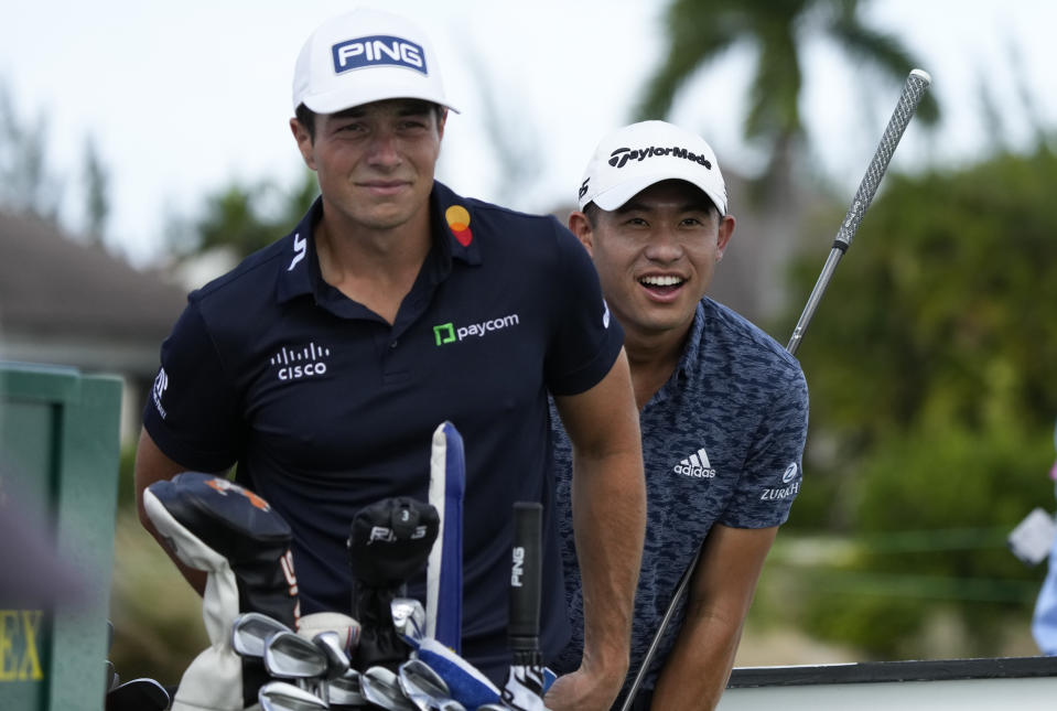 Viktor Hovland, of Norway, left, and Collin Morikawa, of the United States, look for the flag on the green before the tee off at the first hole during the first round of the Hero World Challenge PGA Tour at the Albany Golf Club, in New Providence, Bahamas, Thursday, Dec. 1, 2022. (AP Photo/Fernando Llano)