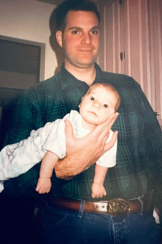 <p>Courtesy of Maggie Timblin</p> Mike Girardi wearing L.L Bean shirt holding Maggie Timblin.