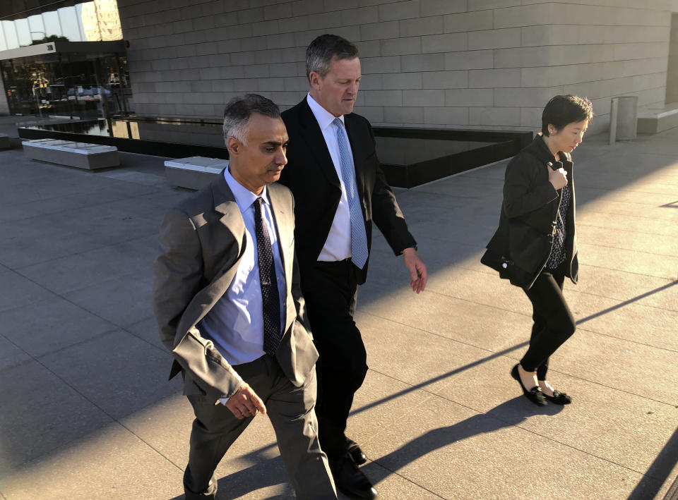 Imaad Zuberi, left, leaves the federal courthouse with his attorney Thomas O'Brien, second from left, in Los Angeles, on Friday, Nov. 22, 2019. Zuberi pleaded guilty to funneling donations from foreigners to U.S. political campaigns. (AP Photo/Brian Melley)