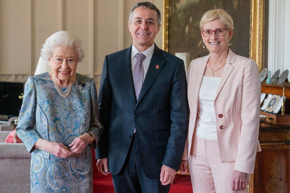 Queen Elizabeth II poses for a photo with the President of Switzerland Ignazio Cassis and his wife Paola Cassis during an audience at Windsor Castle on April 28, 2022 in Windsor, England.