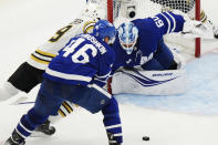 Toronto Maple Leafs goaltender Joseph Woll (60) trips Boston Bruins' John Beecher, left, as Maple Leafs' Ilya Lyubushkin (46) defends during second-period action in Game 6 of an NHL hockey Stanley Cup first-round playoff series in Toronto, Thursday, May 2, 2024. (Frank Gunn/The Canadian Press via AP)