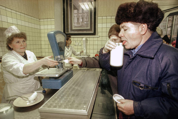 FILE - A man tastes the sour cream, the only remaining dairy product available, at a state-owned store in Moscow, Monday, Dec. 24, 1991. By the fall of 1991, however, deepening economic woes and secessionist bids by Soviet republics had made the collapse all but inevitable. The failed August 1991 coup by the Communist old guard was a major catalyst, dramatically eroding Gorbachev’s authority and encouraging more republics to seek independence. (AP Photo/Alexander Zemlianichenko, File)