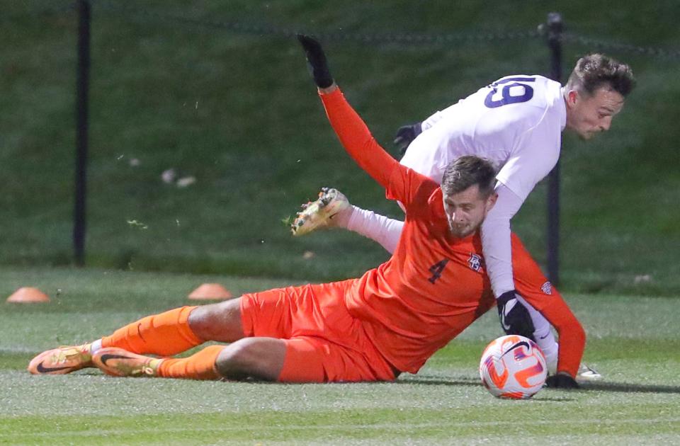 University of Akron's Dyson Clapier, top, gets tangled with BGSU's Amer Dedic on Monday, Oct. 17, 2022 in Akron, Ohio, at FIrstEnergy Stadium.