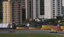 Red Bull's Max Verstappen, left, steers his car followed by Mercedes' Lewis Hamilton, during the Brazilian Formula One Grand Prix at the Interlagos race track in Sao Paulo, Brazil, Sunday, Nov. 14, 2021. (AP Photo/Andre Penner)