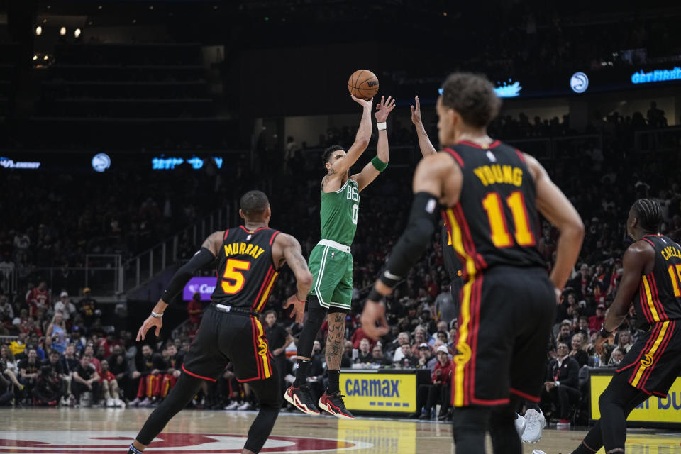 Boston Celtics forward Jayson Tatum (0) shoots and scores against the Atlanta Hawks during the first half of Game 6 of a first-round NBA basketball playoff series, Thursday, April 27, 2023, in Atlanta. (AP Photo/Brynn Anderson)