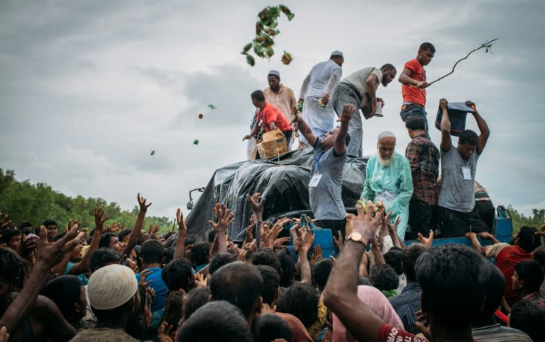 Bangladeshi volunteers from the Chhagalnaiya village council distribute food donations to Rohingya Muslim refugees at Naikhongchhari in Chittagong on September 10, 2017