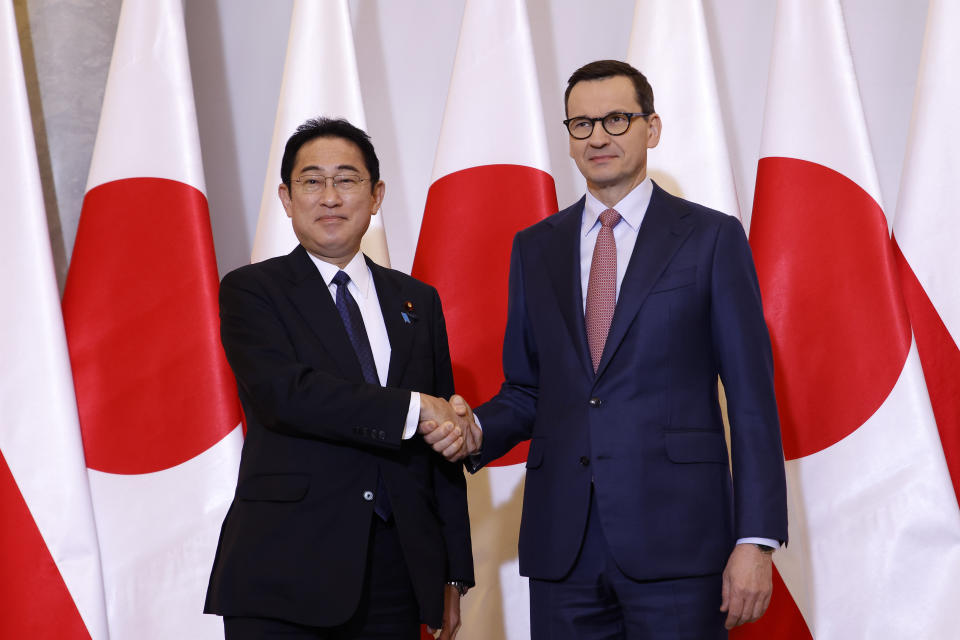 Polish Prime Minister Mateusz Morawiecki, right, welcomes Japanese Prime Minister Fumio Kishida, left, for a meeting in Warsaw, Poland, Wednesday, March 22, 2023. (AP Photo/Michal Dyjuk)