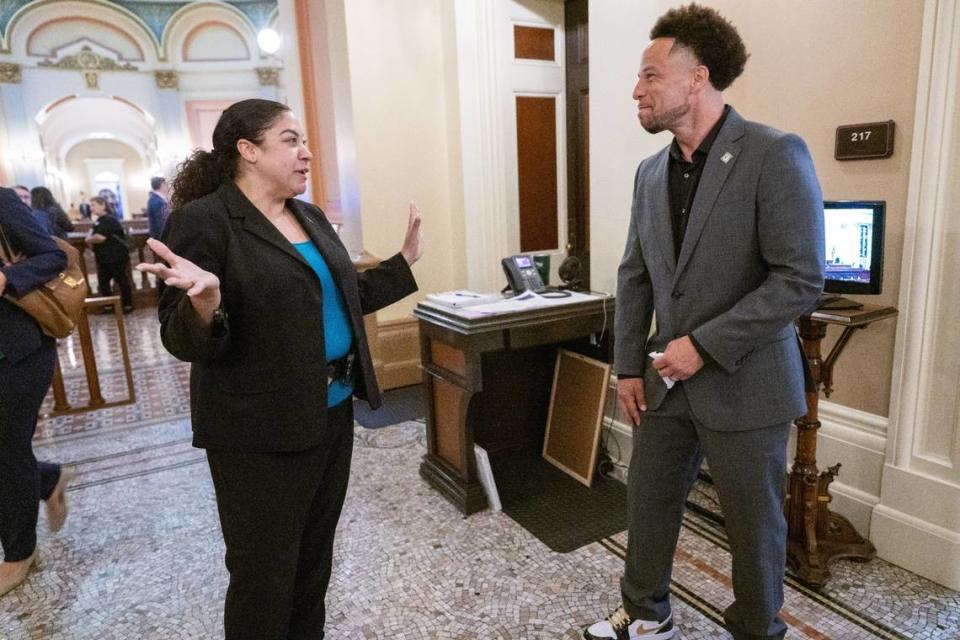 Adrienne Thames, state Senate Sergeant-at-Arms, talks with fellow alum and Sacramento State President Luke Wood on Thursday, June 6, 2024 he attends an Assembly session at the state Capitol to recognize his university as a Black Serving Institution.