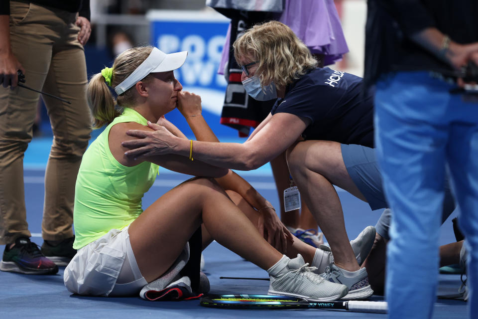 Daria Saville (pictured left) reacts in pain after hurting her knee during the Japan Open.