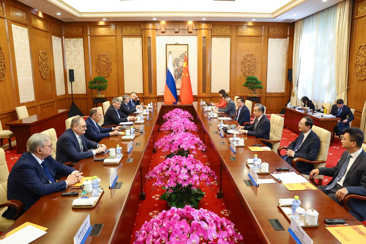 Russian Foreign Minister Sergei Lavrov and Chinese Foreign Minister Wang Yi attend a meeting in Beijing (via REUTERS)