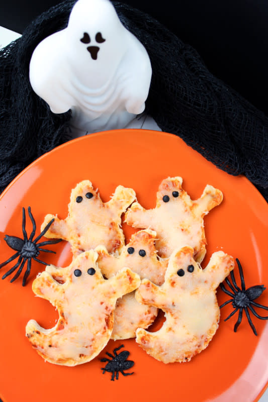 <p>Crayons and Cravings</p><p>Pair these simple-to-make ghost pizzas at a party with mummy hot dogs and you'll have everyone filled up Halloween night before heading out and trick or treat. </p><p><strong>Get the recipe here: <a href="https://crayonsandcravings.com/ghost-pizzas" rel="nofollow noopener" target="_blank" data-ylk="slk:Ghost Pizza;elm:context_link;itc:0;sec:content-canvas" class="link rapid-noclick-resp">Ghost Pizza </a></strong></p>