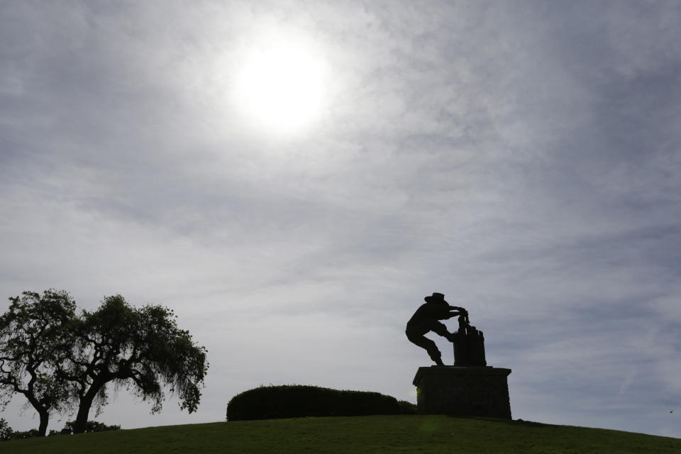 In this photo taken Saturday, April 13, 2013 the Grape Crusher Statue is silhouetted near Highway 29 in Napa, Calif. Highway 29 is a straight shot from the south end of the valley marked by the famous Grape Crusher Statue. Along the way are dozens of restaurants and wineries, including the Robert Mondavi Winery and Inglenook, the winery restored by director Francis Ford Coppola. (AP Photo/Eric Risberg)