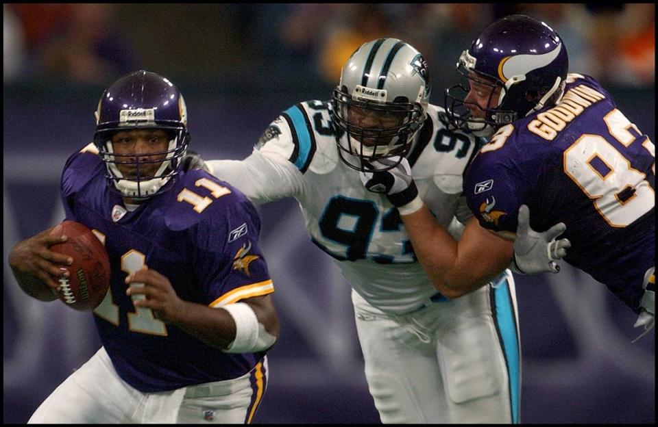 09/22/02: Minnesota Viking’s Quarterback Daunte Culpepper scramble to get free of the grasp of Carolina Panther’s <span class="caas-xray-inline-tooltip"><span class="caas-xray-inline caas-xray-entity caas-xray-pill rapid-nonanchor-lt" data-entity-id="Michael_Rucker_(baseball)" data-ylk="cid:Michael_Rucker_(baseball);pos:2;elmt:wiki;sec:pill-inline-entity;elm:pill-inline-text;itc:1;cat:Athlete;" tabindex="0" aria-haspopup="dialog"><a href="https://search.yahoo.com/search?p=Michael%20Rucker" data-i13n="cid:Michael_Rucker_(baseball);pos:2;elmt:wiki;sec:pill-inline-entity;elm:pill-inline-text;itc:1;cat:Athlete;" tabindex="-1" data-ylk="slk:Michael Rucker;cid:Michael_Rucker_(baseball);pos:2;elmt:wiki;sec:pill-inline-entity;elm:pill-inline-text;itc:1;cat:Athlete;" class="link ">Michael Rucker</a></span></span> (93) despite the efforts of Minnesota teammate Hunter Goodwin, Sunday afternoon September 22, 2002, at the Hubert H. Humprey Metrodome.PATRICK SCHNEIDER/STAFF PATRICK SCHNEIDER