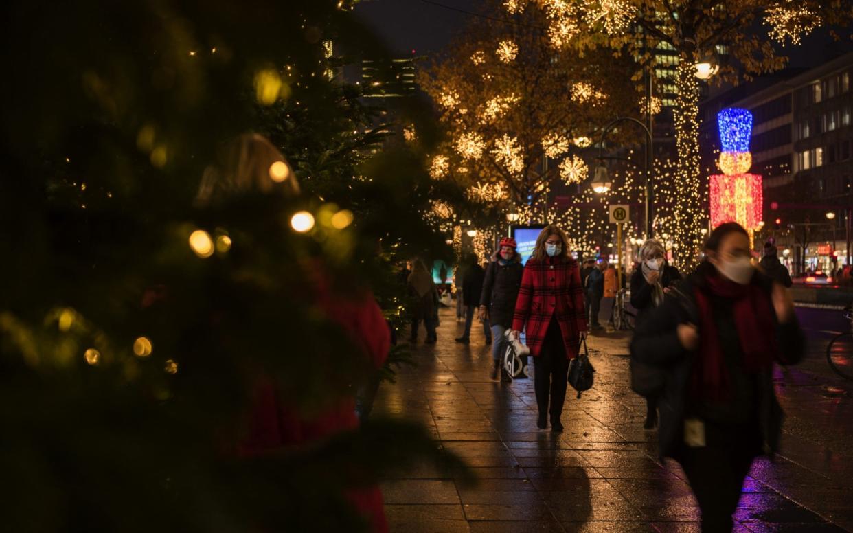 Shoppers wearing protective face mask pass festive light displays on Kurfuerstendamm Avenue in Berlin, Germany, on Thursday, Nov. 26, 2020. WithÂ BlackÂ FridayÂ almost underway, equity traders are bracing for a holiday season where brick-and-mortar businesses that lack strong digital platforms could suffer. Photographer: Stefanie Loos/Bloomberg -  Stefanie Loos/Bloomberg