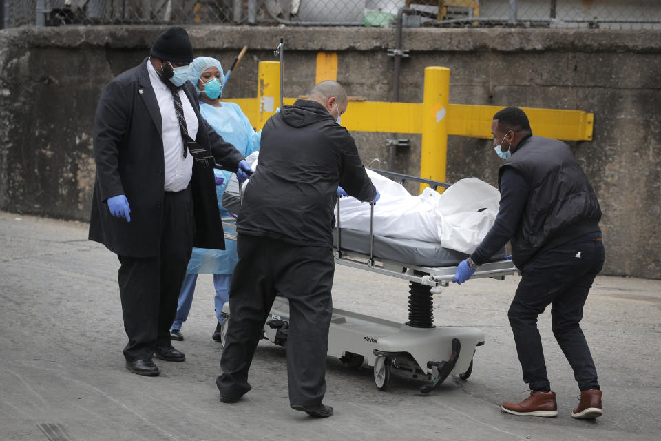 Workers wheel a deceased person outside of Brooklyn Hospital Center during the coronavirus disease (COVID-19) outbreak in the Brooklyn borough of New York (Brendan McDermid / Reuters)