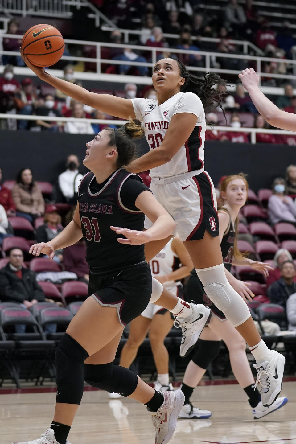 Stanford guard Haley Jones, top, shoots against Santa Clara guard Ashley Hiraki (31) during the first half of an NCAA college basketball game in Stanford, Calif., Wednesday, Nov. 30, 2022. (AP Photo/Jeff Chiu)