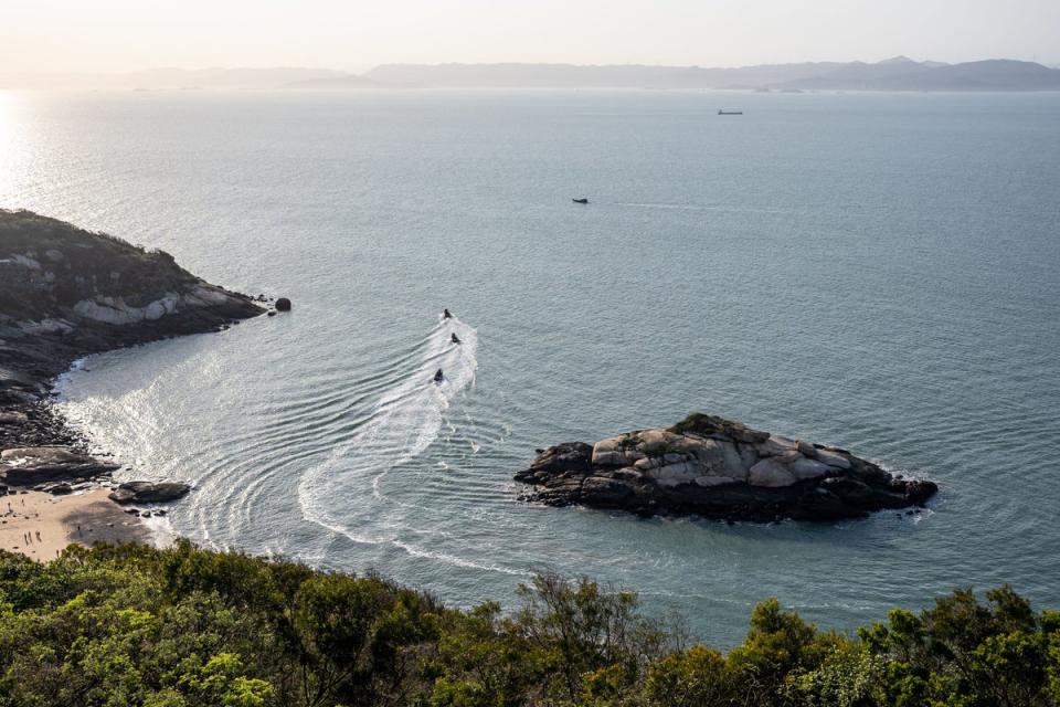 Three military boats from Taiwan’s Amphibious Reconnaissance and Patrol Unit patrol the Matsu Islands with a view of China’s Fujian province in the background (AFP via Getty)