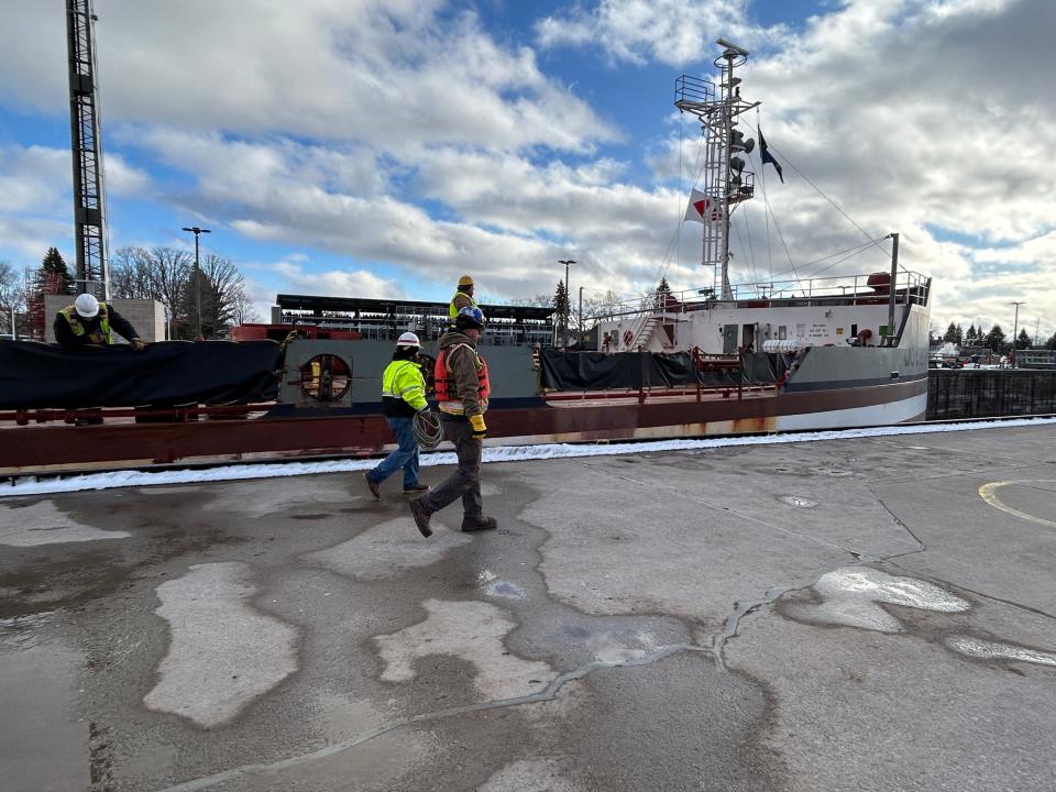 Workers on board the Joseph L. Block and at the Soo Locks work together to tie off the massive freighter on Friday, March 22, 2024.