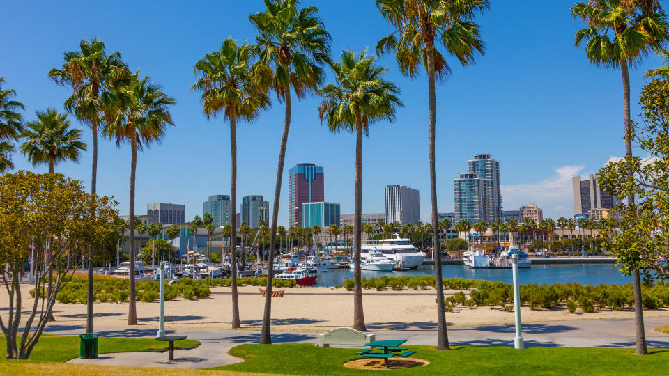 Rainbow Harbor with city skyline at Long Beach , CA.