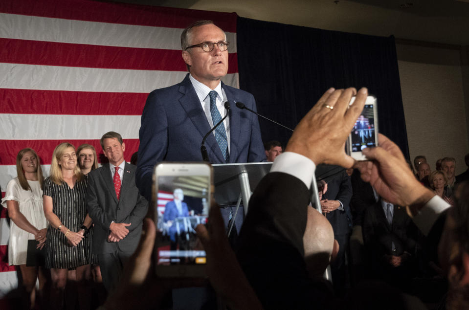 Georgia Republican Lt. Gov. Casey Cagle, left, and Secretary of State Brian Kemp celebrate during a unity rally, Thursday, July 26, 2018, in Peachtree Corners, Ga. The pair faced off against each other in a heated gubernatorial runoff race which Kemp won. (AP Photo/John Amis)