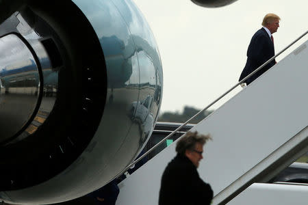 President Donald Trump (R), trailed by senior adviser Steve Bannon (bottom), boards Air Force One to return to Washington after spending the weekend at the Mar-a-Lago Club, from Palm Beach International Airport in West Palm Beach, Florida, March 5, 2017. REUTERS/Jonathan Ernst