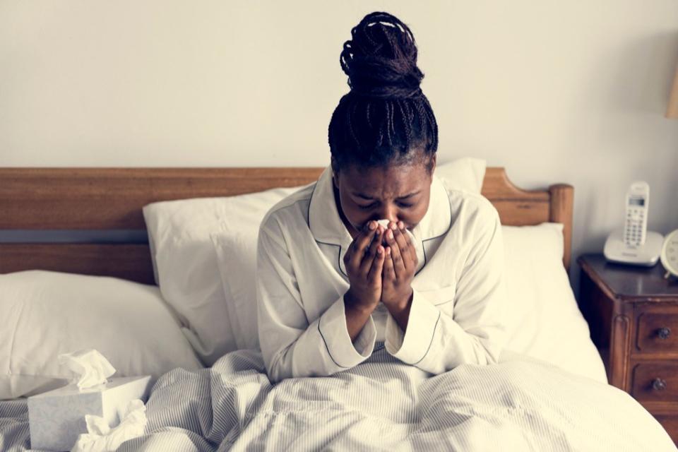 woman sick in bed exposed to serious flu risk