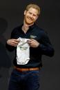 <p>During the Invictus Games launch in The Hague, Netherlands, Harry is presented with an Invictus Games outfit for baby Archie. </p>