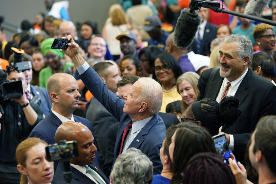 President Joe Biden takes a selfie as he greets members of the audience after speaking during a visit to a mobile COVID-19 vaccination unit at the Green Road Community Center in Raleigh, N.C., Thursday, June 24, 2021. (AP Photo/Susan Walsh)
