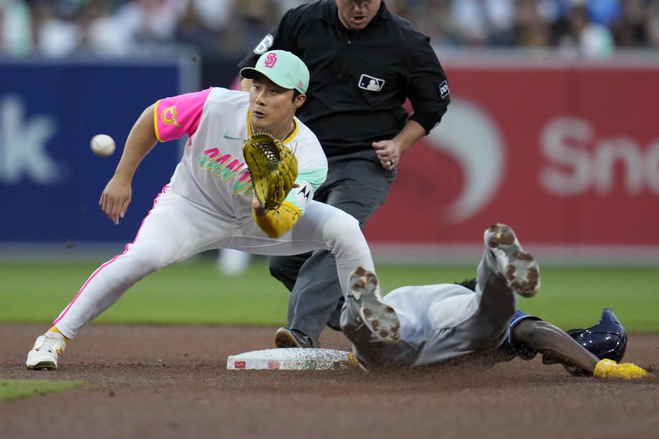 San Diego Padres second baseman Ha-Seong Kim waits for the throw before tagging out Tampa Bay Rays' Randy Arozarena as Arozarena tries to steal second base during the fourth inning of a baseball game Friday, June 16, 2023, in San Diego. (AP Photo/Gregory Bull)