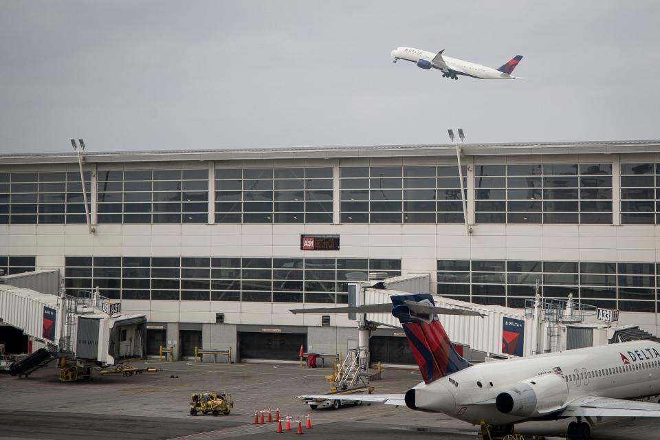 A Delta aircraft takes off near the McNamara Terminal at Detroit Metro Airport in Romulus, Thursday, March 12, 2020.