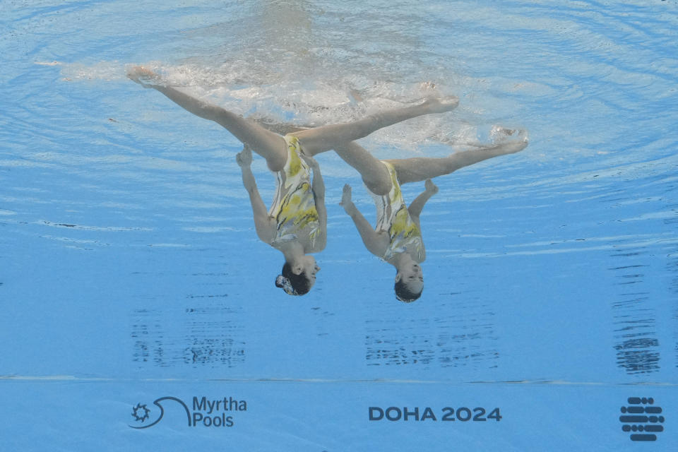 Wang Liuyi and Wang Qianyi, of China, compete in the women's duet technical final of artistic swimming at the World Aquatics Championships in Doha, Qatar, Monday, Feb. 5, 2024. (AP Photo/Lee Jin-man)