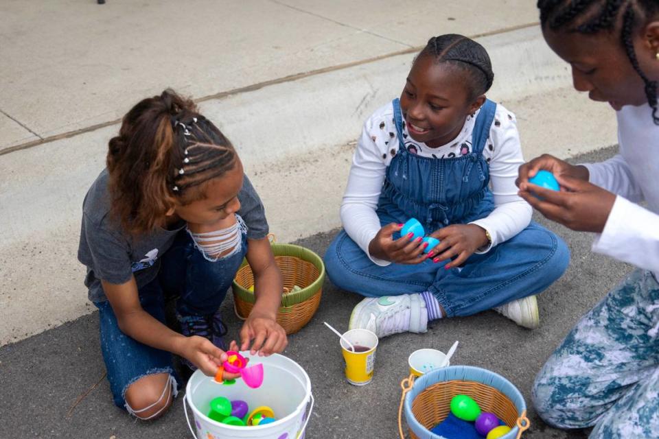 Million Sharpe, 9, (left) Samantha Turner , 9, (center) and Monique Hill, 15, (right) look through the eggs they found during the annual Easter egg hunt at the Como Community Center in Fort Worth on Saturday, April 8, 2023.