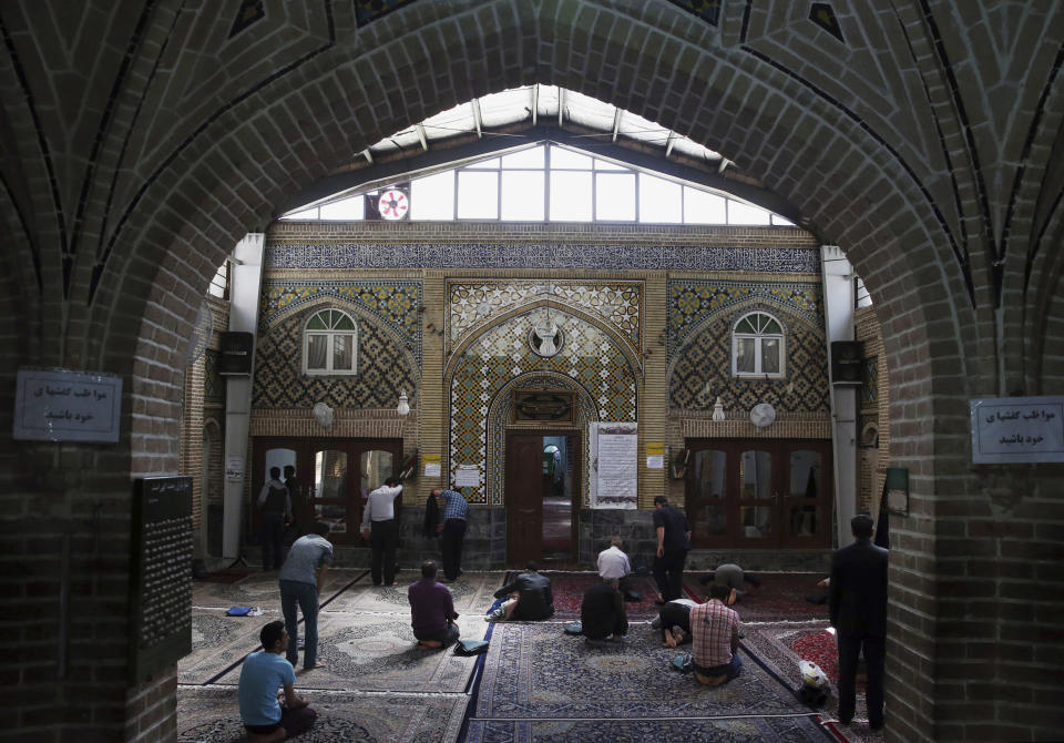 Iranians pray in a mosque in the old main bazaar in Tehran, Iran, on April 26, 2015.