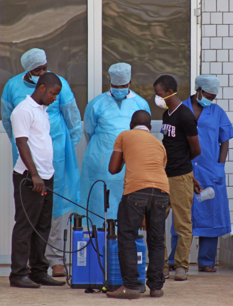 In this photo taken on Saturday, March 29, 2014, medical personnel at the emergency entrance of a hospital receive suspected Ebola virus patients in Conakry, Guinea. Senegal has closed its land border with neighboring Guinea to prevent the spread of the Ebola outbreak, which has killed at least 70 people. Senegal's Interior Ministry announced the border closure Saturday. It also said officials in the southern region of Kolda closed a weekly market which draws thousands of people from the neighboring West African countries of Guinea, Gambia and Guinea-Bissau. Guinea confirmed last week that several victims of hemorrhagic fever in the country's southern region had tested positive for Ebola. (AP Photo/ Youssouf Bah)