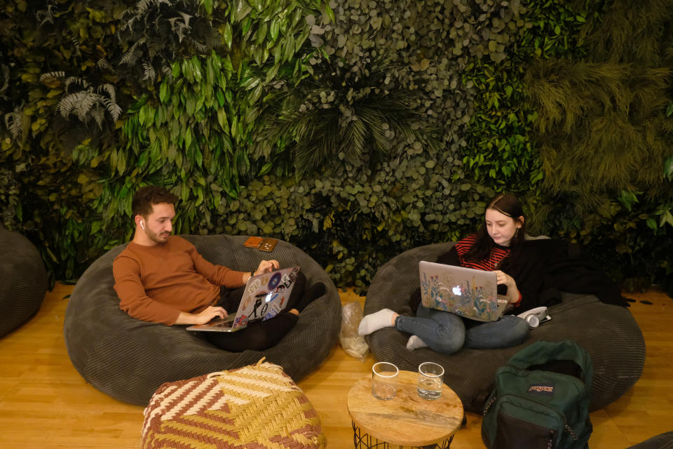 BERLIN, GERMANY - NOVEMBER 21: A young man and woman work on laptop computers in the cafeteria of the Factory Berlin Kreuzberg location during a visit by German State Sectretary for Digitalization Dorothee Bär on November 21, 2018 in Berlin, Germany. Berlin city authorities are seeking to make Berlin a hub of digital innovation and have successfully drawn a variety of tech companies and startups. The Factory Berlin, with two locations in the city, provides members a venue for workspaces as well as access to potential investors.  (Photo by Sean Gallup/Getty Images)