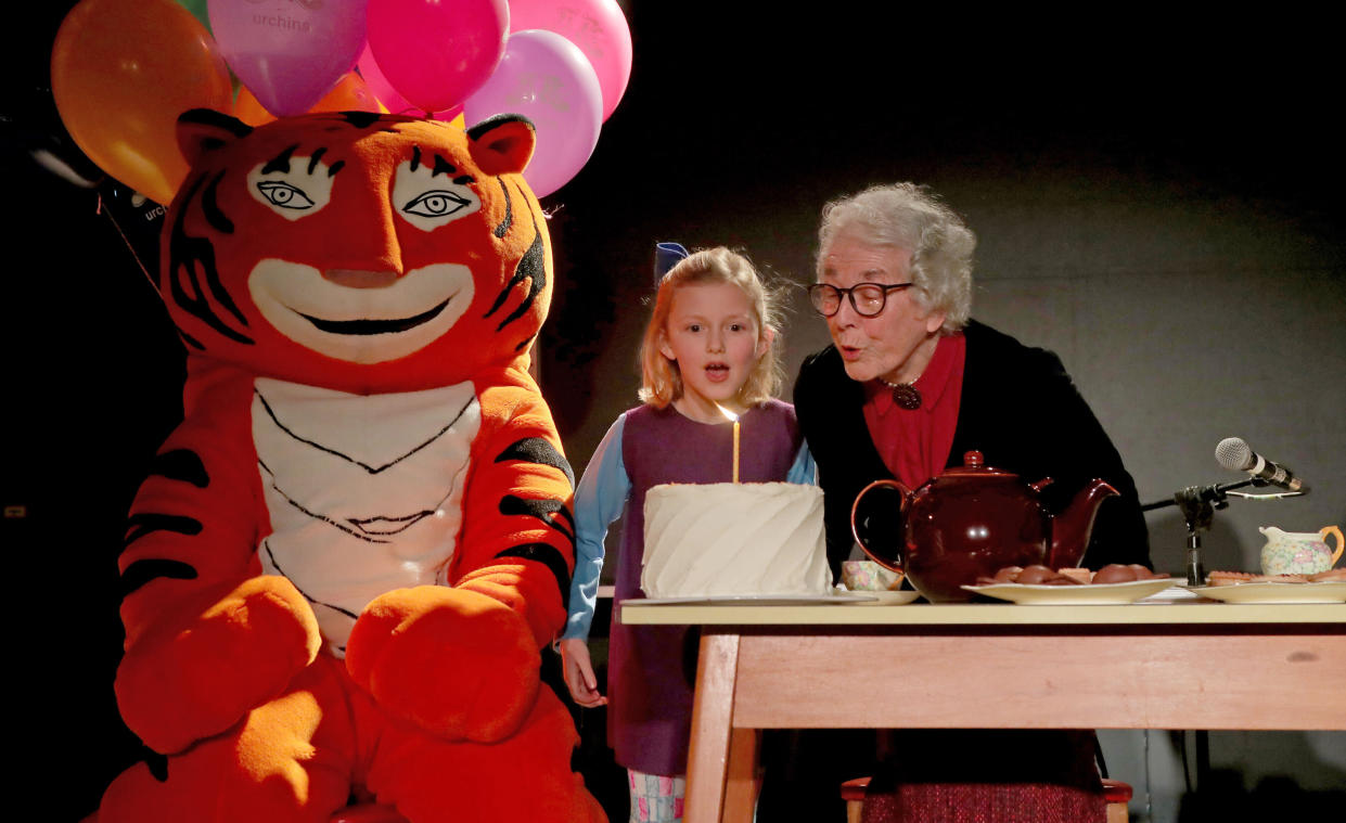 Judith Kerr author of the Tiger Who Came to Tea, accompanied by Kitty Forbes, 7, dressed as the character Sophie from the book, blow out a candle to celebrate the 50th anniversary of the book at the Storystock Festival at Circus West Village, Battersea Power Station, Battersea, London.