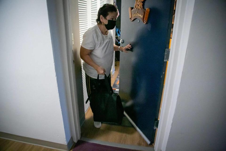 Marcia Gomez, 74, brings her just-delivered meals inside her Coral Reef apartment on Jan. 7, 2021. She received them through Miami-Dade’s senior meals program, launched in the spring of 2020 to encourage the most vulnerable residents to isolate at home.