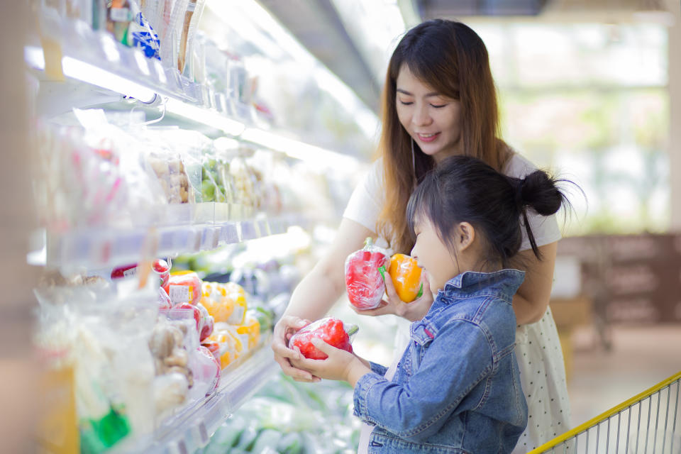 Woman at the grocery store with her child