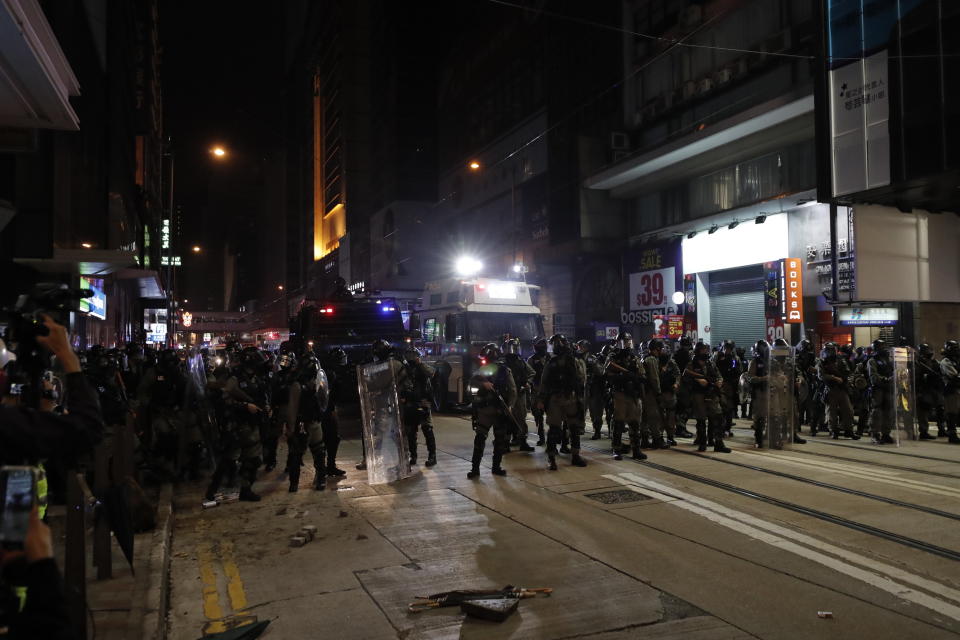 Police arrive to chase away protestors in Hong Kong, Wednesday, Jan. 1, 2020. Hong Kong toned down its New Year’s celebrations amid the protests that began in June and which have dealt severe blows to the city’s retail, tourism and nightlife sectors. (AP Photo/Lee Jin-man)